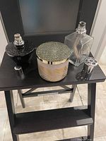 Black round Maison Berger lamp, clear square Maison Berger lamp, jar candle with lid, extra catalytic top visible