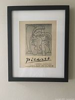 Full view of framed lithograph print on wall