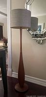 Full view of teak floor lamp with shade
