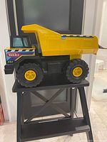 Side view of Tonka dump truck showing color, size and wheel design