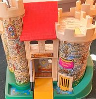 Front view showing brand plaque, drawbridge, towers, red roof, base