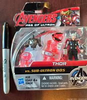 Front view of sealed Avengers Age of Ultron Thor vs Sub-Ultron 005 action figure pack alongside marker for scale