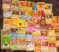 Spread of 40 early Pokémon TCG cards showing variety of Pokémon, Trainer and Energy cards