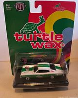 Front view of factory-sealed blister card showing M2 Machines 1966 Dodge Charger Turtle Wax die-cast