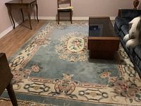Full view of large blue floral area rug on floor