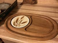 Full view of wooden tray showing ceramic tile insert and recessed cracker section