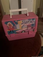 Front view of pink Barbie lunchbox closed