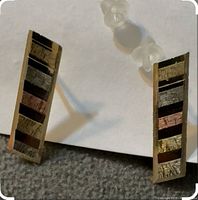 Front view showing multi-tone rectangular design on both earrings