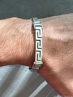 Bracelet worn on wrist showing size and Greek key pattern