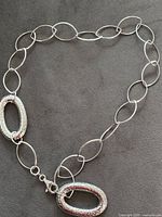 Full view of sterling silver necklace showing oval link design and two large oval stations