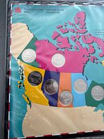 Front of map holder showing six commemorative quarters in western Canada section