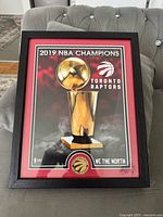 Front view showing framed print, bronze coin, and overall design