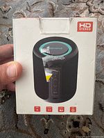 Front of sealed speaker box showing product image and controls