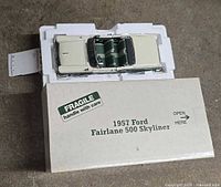 Model in styrofoam insert with outer cover showing label