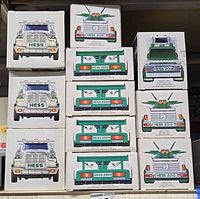 Stack of eleven Hess toy truck boxes showing fronts and ends with year markings