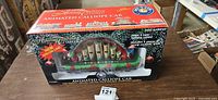 Front of boxed Lionel Holiday Tradition Express Animated Calliope Car showing window display and graphics
