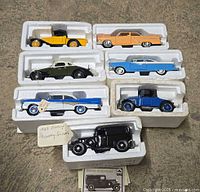 Group of seven diecast cars in Styrofoam inserts