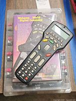 Loose remote placed atop packaged remote showing overall appearance
