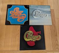 Front covers of three Chicago LPs laid out on floor