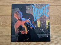 Front album cover featuring Bowie and title