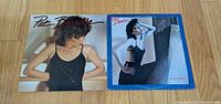Front jackets of both Pat Benatar albums on wooden floor
