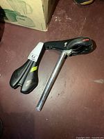 Two bicycle saddles, one with seat post