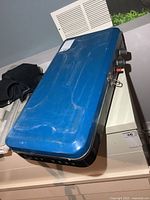 Closed stove showing blue lid and overall size