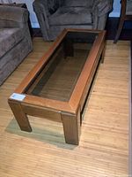Full view of rectangular wood coffee table with glass insert