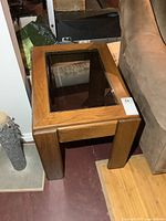 Top view of first wood end table showing glass inset and wood grain