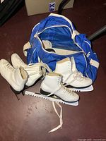 Both pairs of skates and blue bag overview