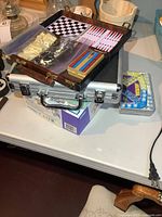 Stacked cases and game tins showing overall lot