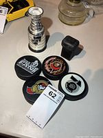 Pucks, trophy and stick end overall view