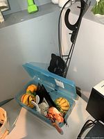 Black metal cat coat rack and blue bin with assorted decor