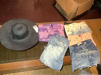 All shorts, capris and sun hat on table