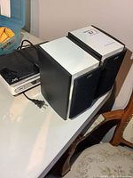 Main unit with attached power cord and pair of speakers