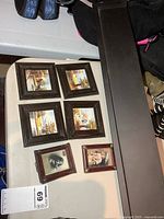 All items grouped: four square paintings, two small prints, long wall shelf