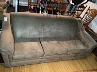 Front view of brown microfiber three-seat sofa