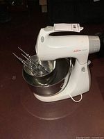 Entire mixer with bowls and attachments visible