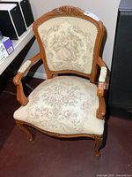 Front view showing full chair, wood frame and upholstery pattern