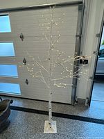Full view of 6-ft LED birch-style decorative tree showing trunk, branches with illuminated LEDs, and square base