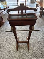 Front view of Bombay Company valet stand showing tray and trouser bar