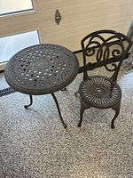 Full view of integrated cast iron chair and side table
