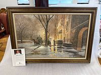 Framed giclée print with information card visible