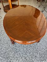 Glossy oval tabletop showing wood grain pattern
