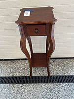 Front view showing full table, drawer, lower shelf, cabriole legs