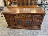 Front view of solid wood sideboard showing doors, drawer, hardware and finish
