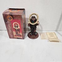 Figurine with box and paperwork