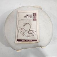 Closed clamshell case with manual on top