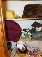 Closet shelves with blankets, compression sleeve packaging, shower head, knee brace