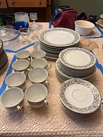 Stacks of plates and cups showing pattern and quantity